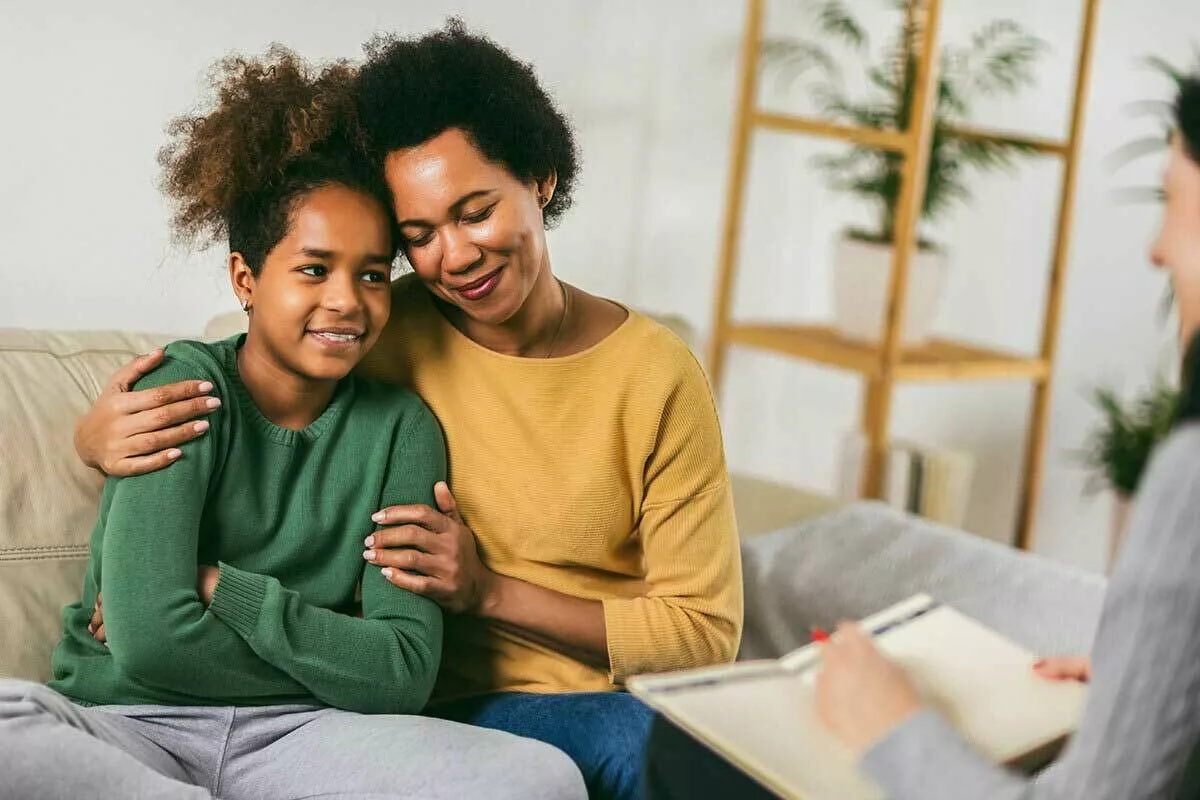 Child and parent/caregiver hugging