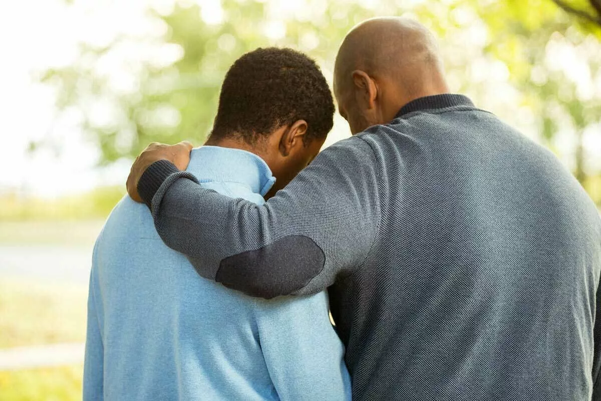 Child and parent/caregiver hugging